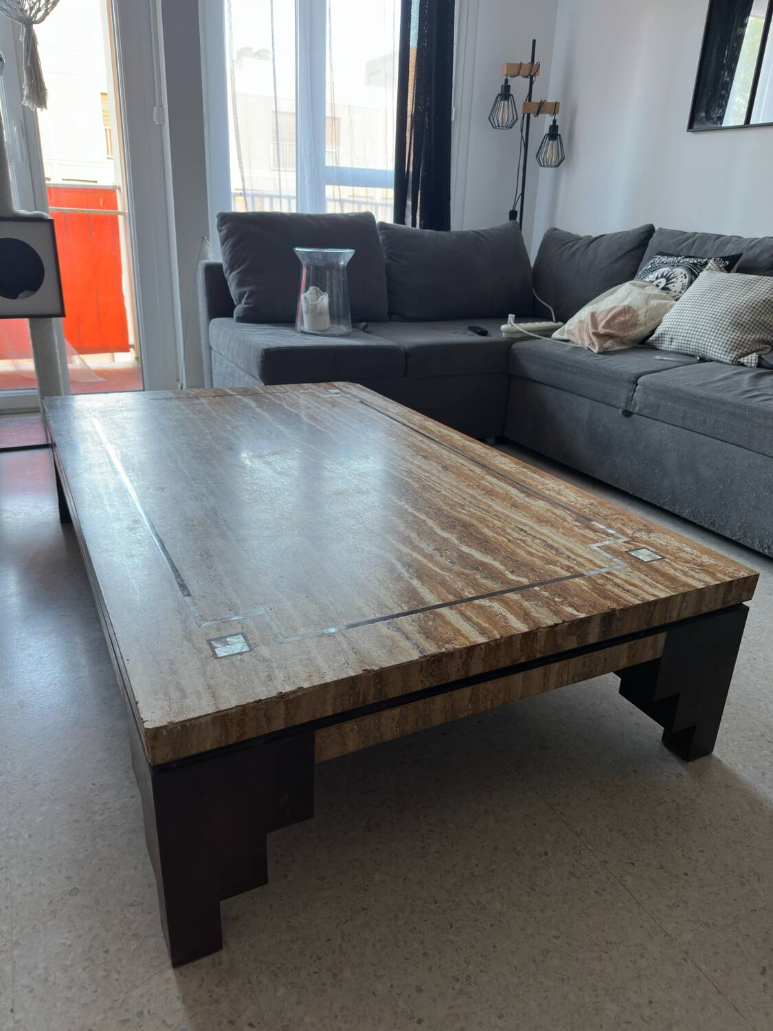 Coffee table in travertine with mother-of-pearl inlays.