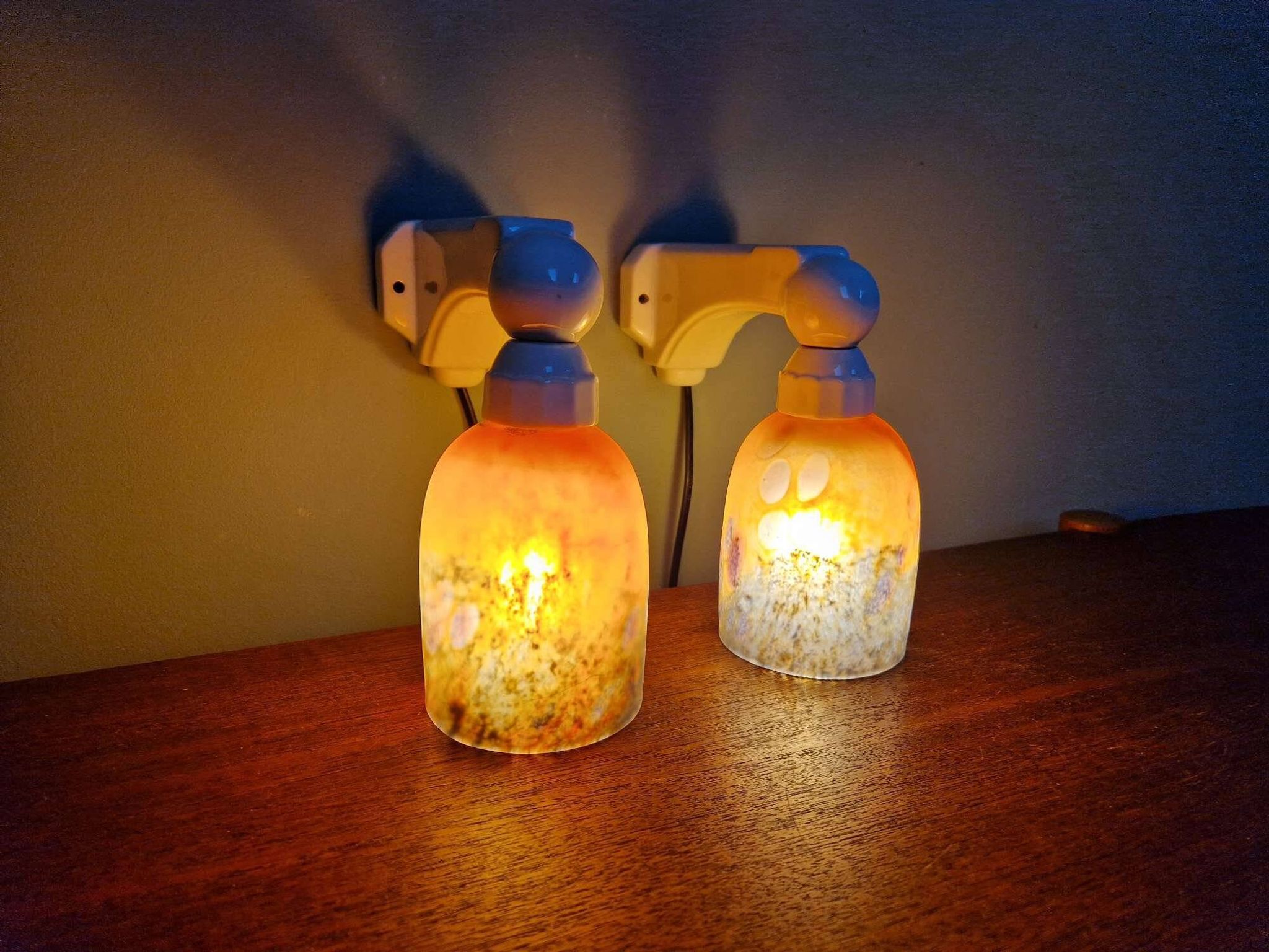 Pair of Art Deco wall sconces in multicoloured porcelain and frosted glass.