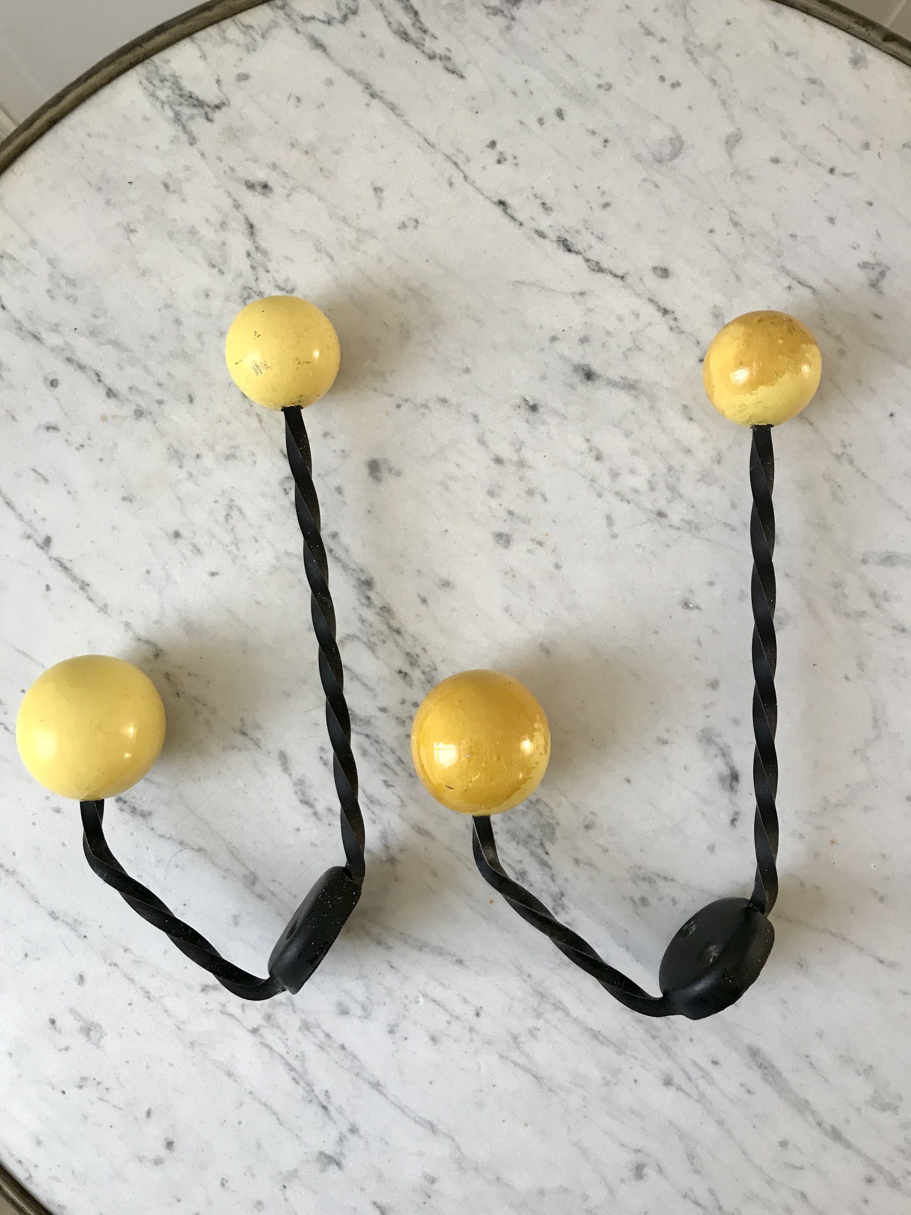 Duo of hooks balls in yellow wood and black iron 60s