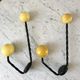 Duo of hooks balls in yellow wood and black iron 60s