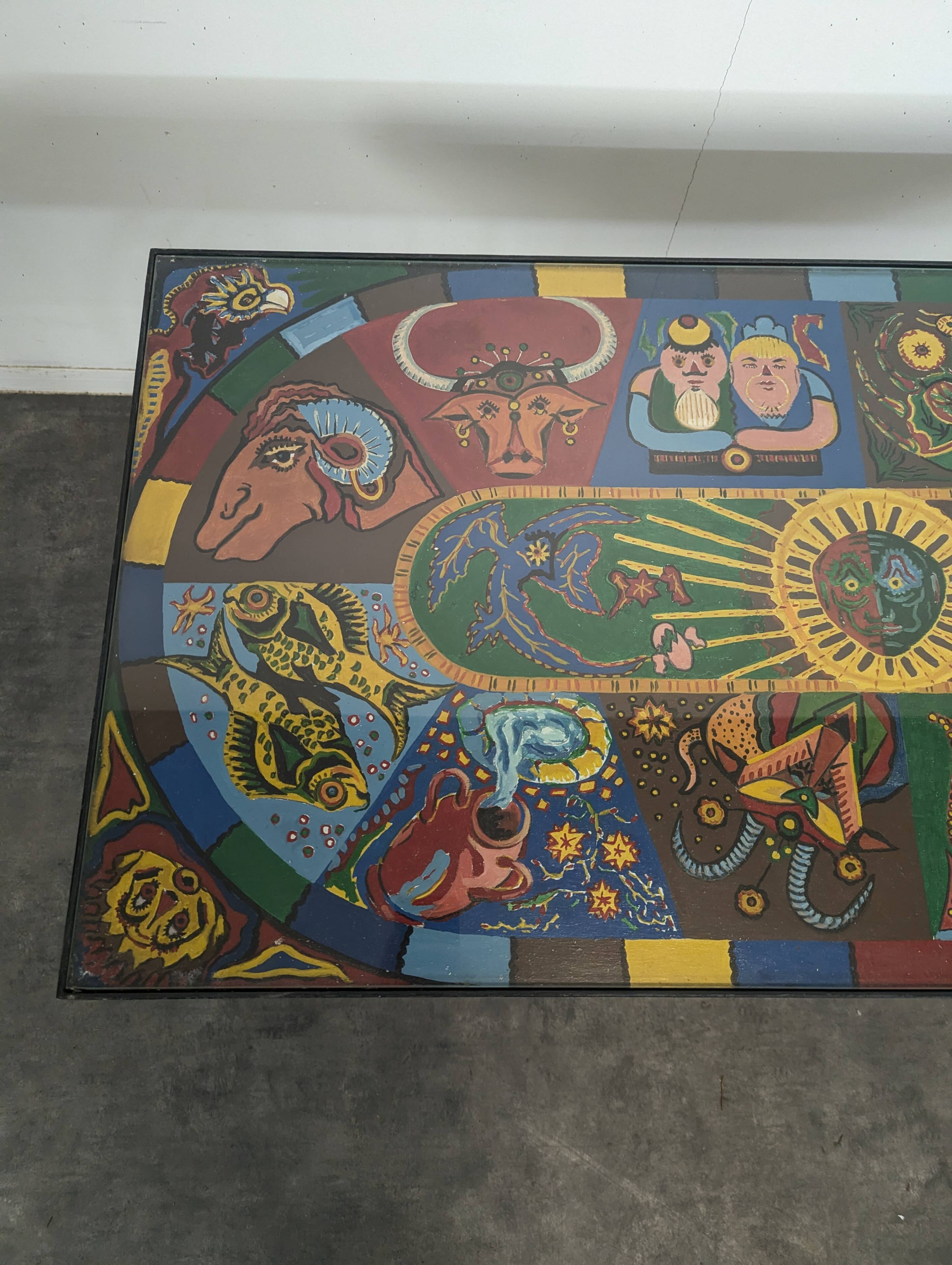 Chrome steel coffee table with zodiac signs decoration.