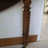 Mid-19th-century walnut round table with shutters, flaps