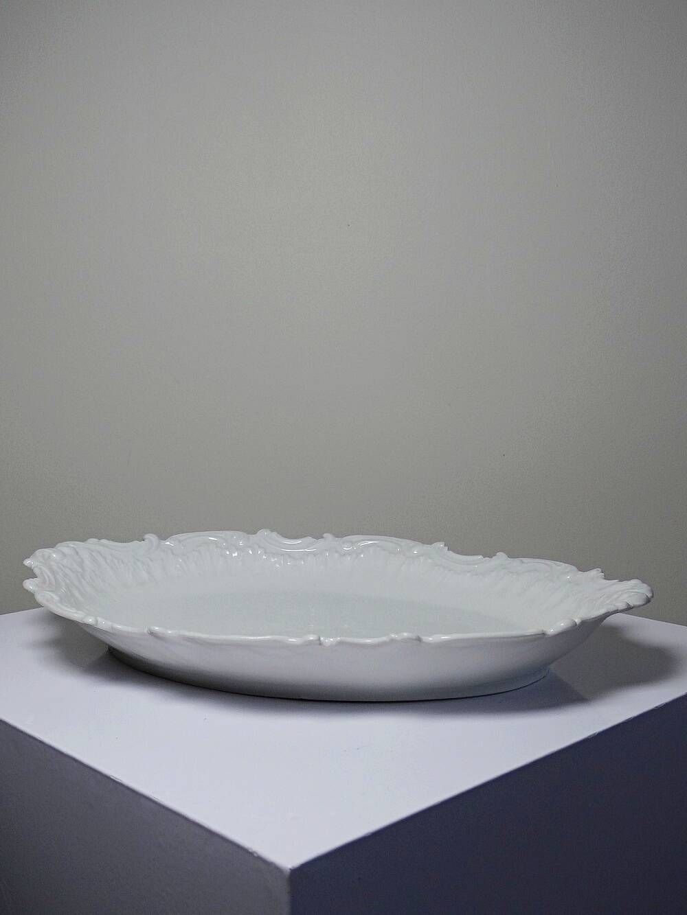 Antique deep dish in white Limoges porcelain, with rockwork relief.