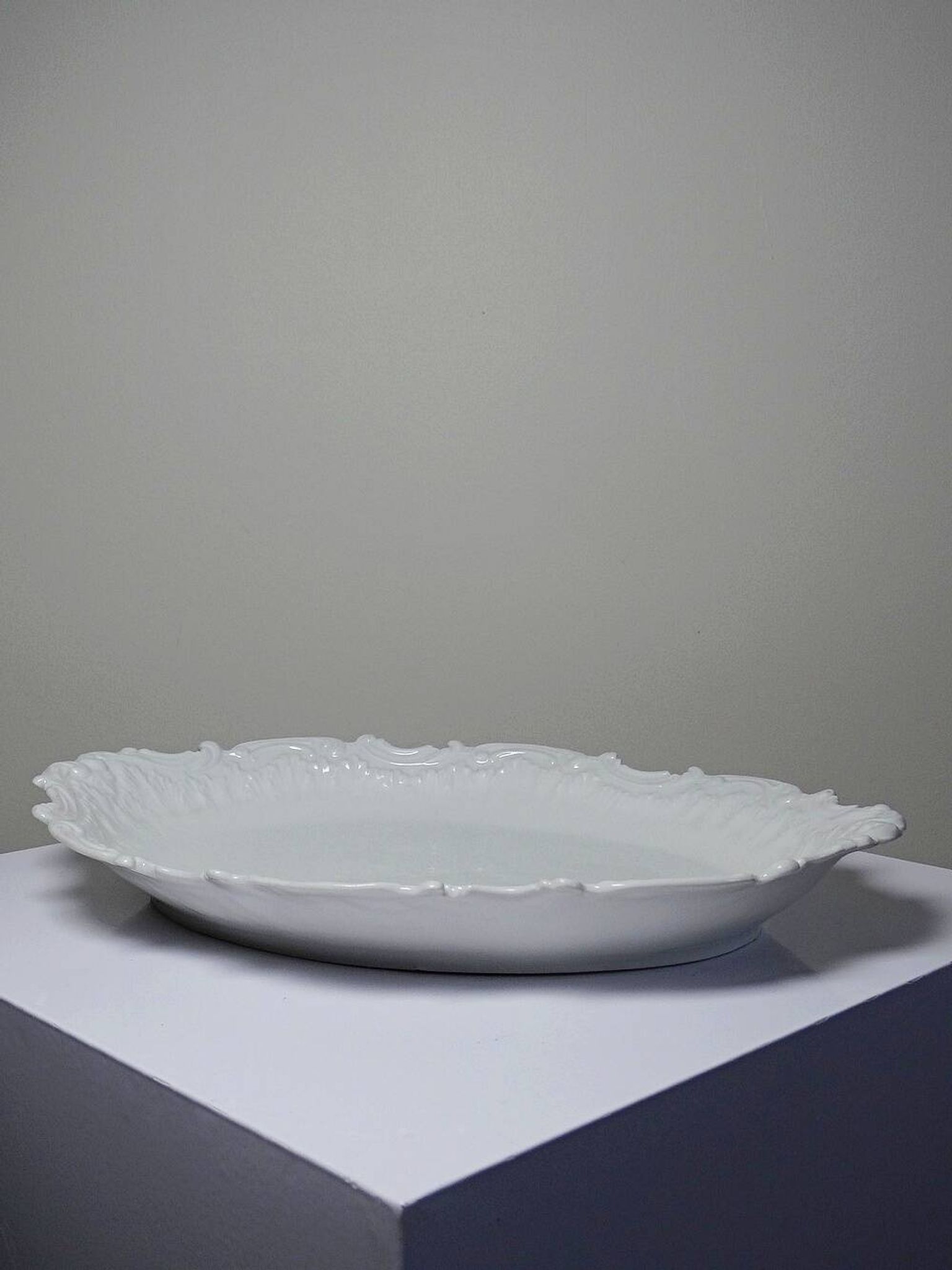 Antique deep dish in white Limoges porcelain, with rockwork relief.