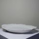 Antique deep dish in white Limoges porcelain, with rockwork relief.
