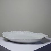 Antique deep dish in white Limoges porcelain, with rockwork relief.