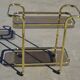 Golden metal and smoked glass dessert table