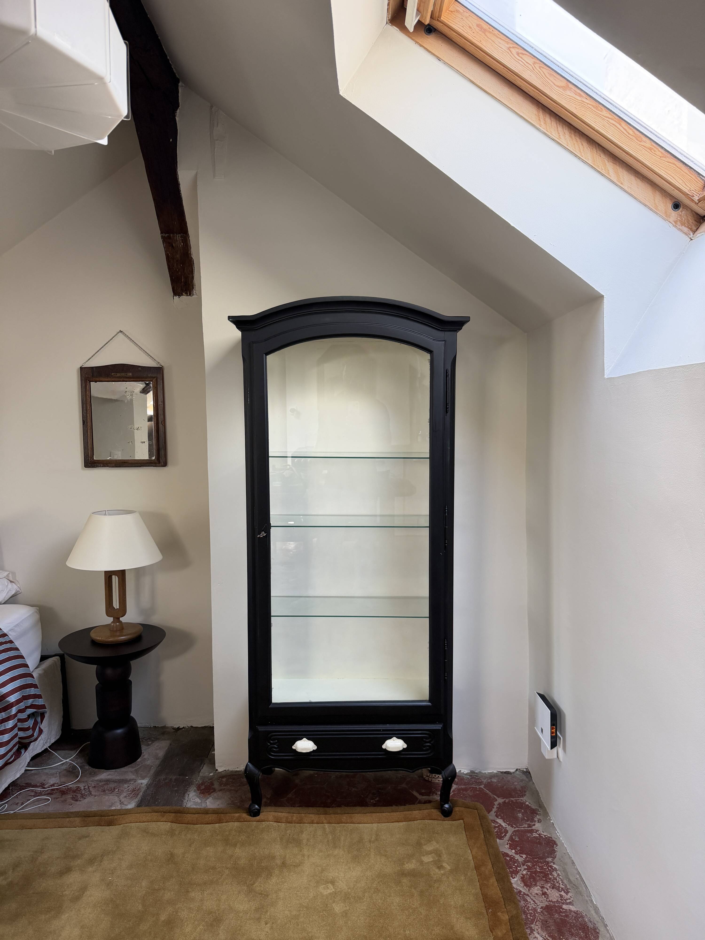 Antique display cabinet repainted in black.