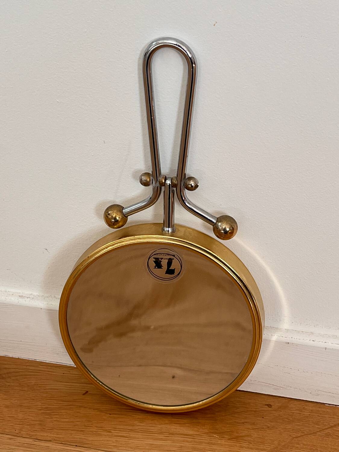 Magnifying brass mirror