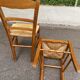 2 wooden dining chairs with rush seats from the 1970s.