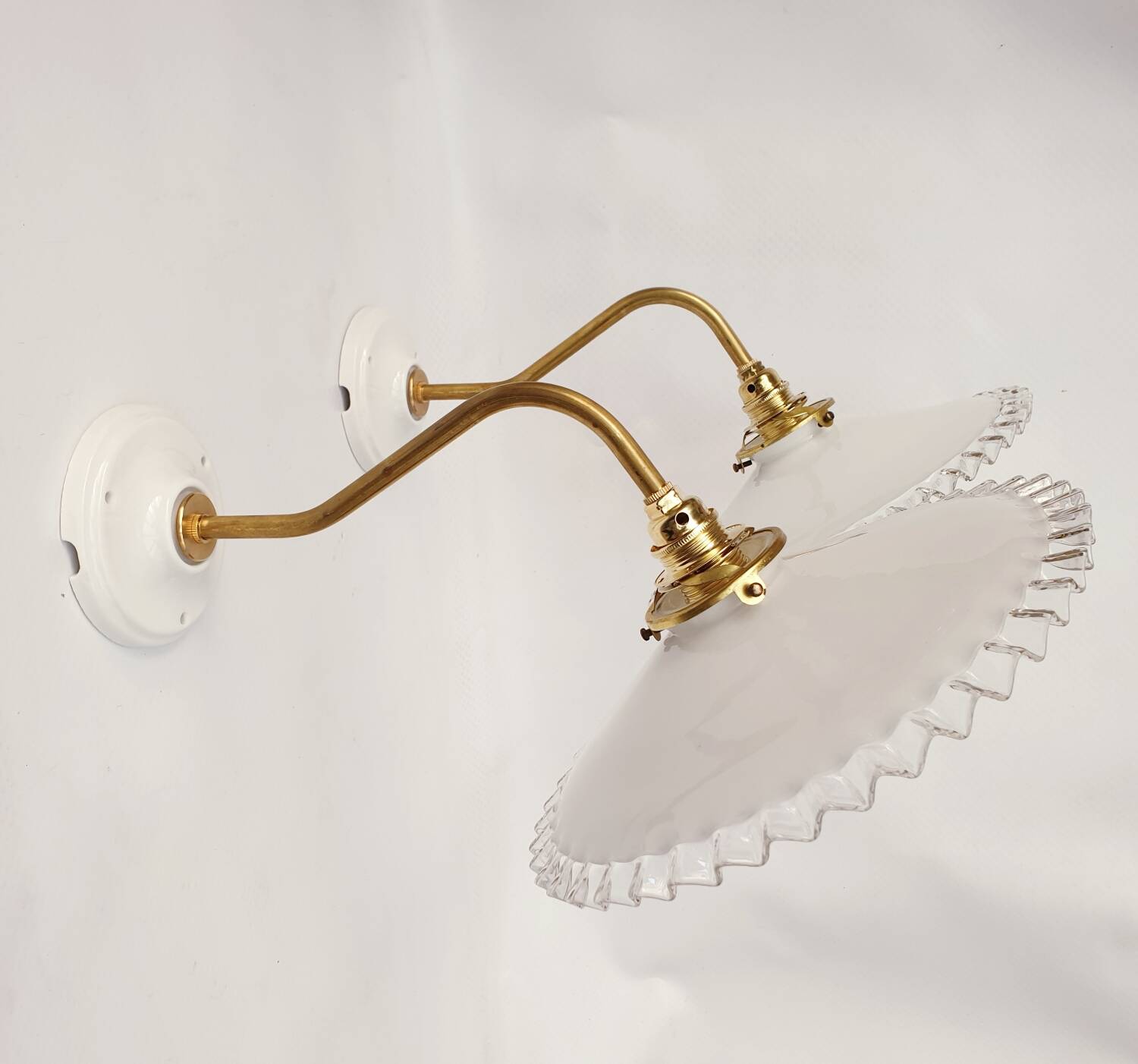 Swan neck sconces in serrated opaline