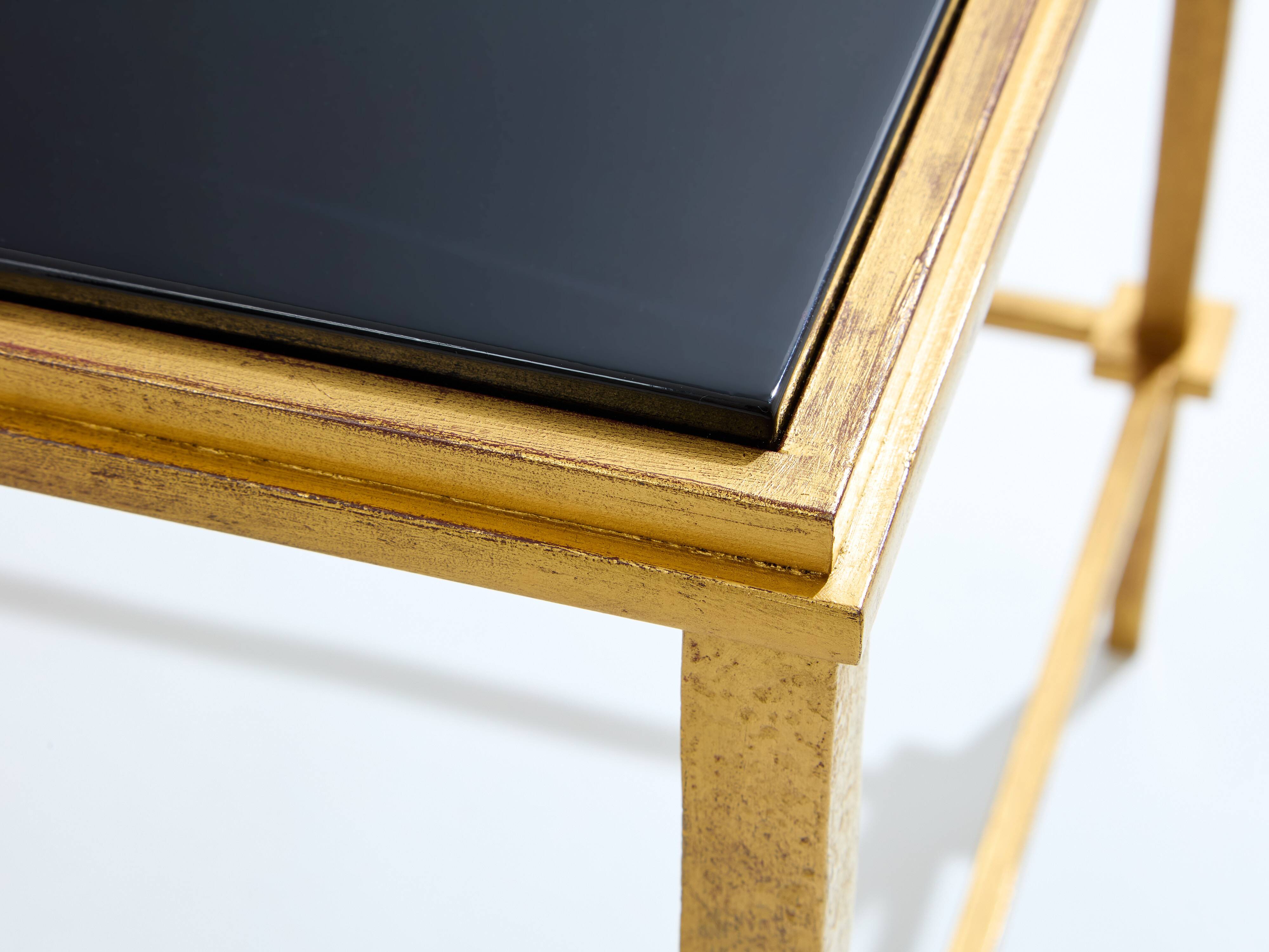 Pair of side tables in gilded iron and black lacquer Maison Ramsay 1950