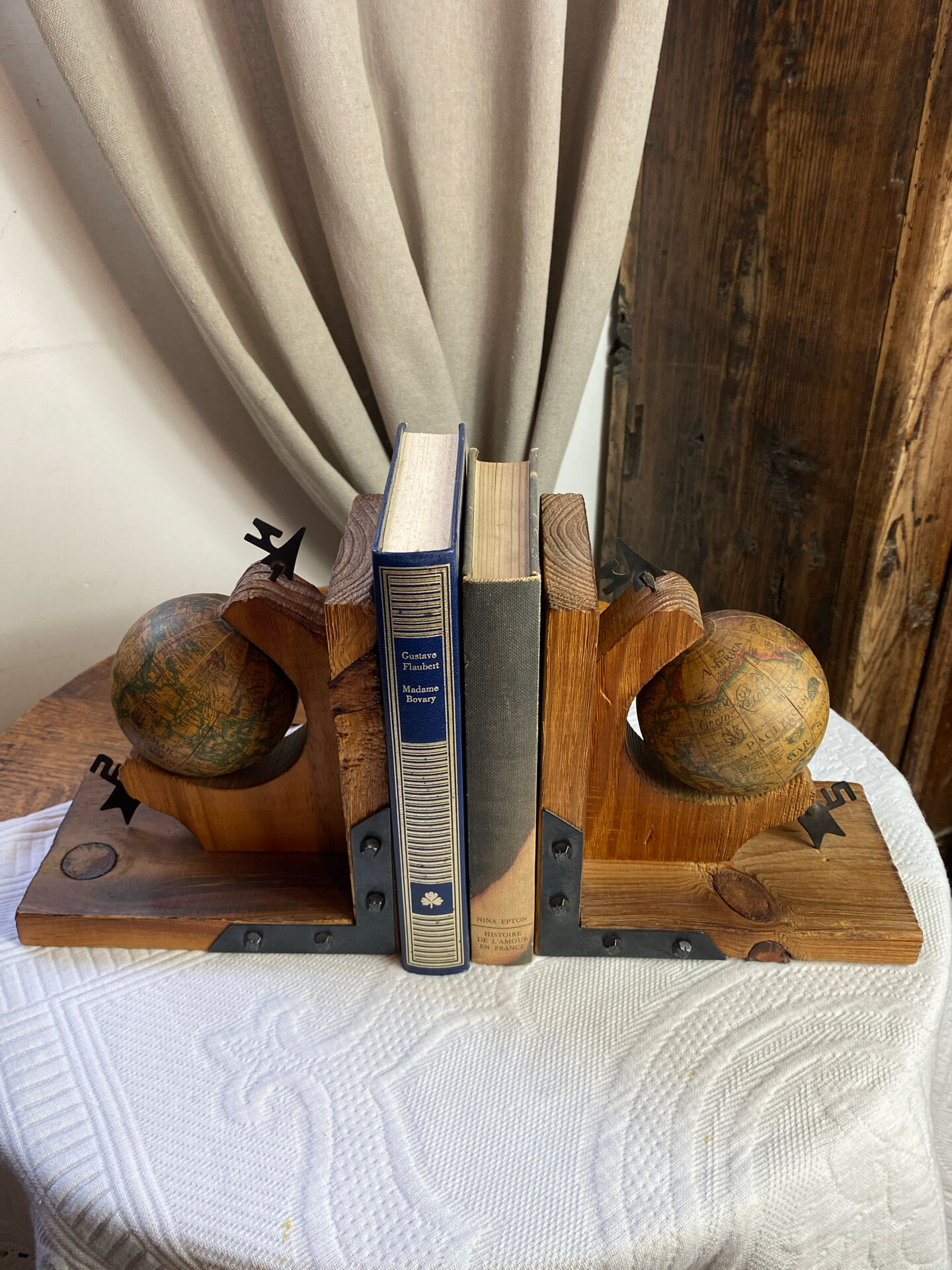 Pair of wooden bookends, rotating globes