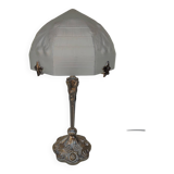 Art Nouveau style lamp, in bronze and frosted glass.