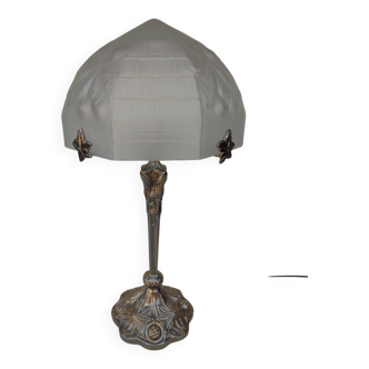 Art Nouveau style lamp, in bronze and frosted glass.