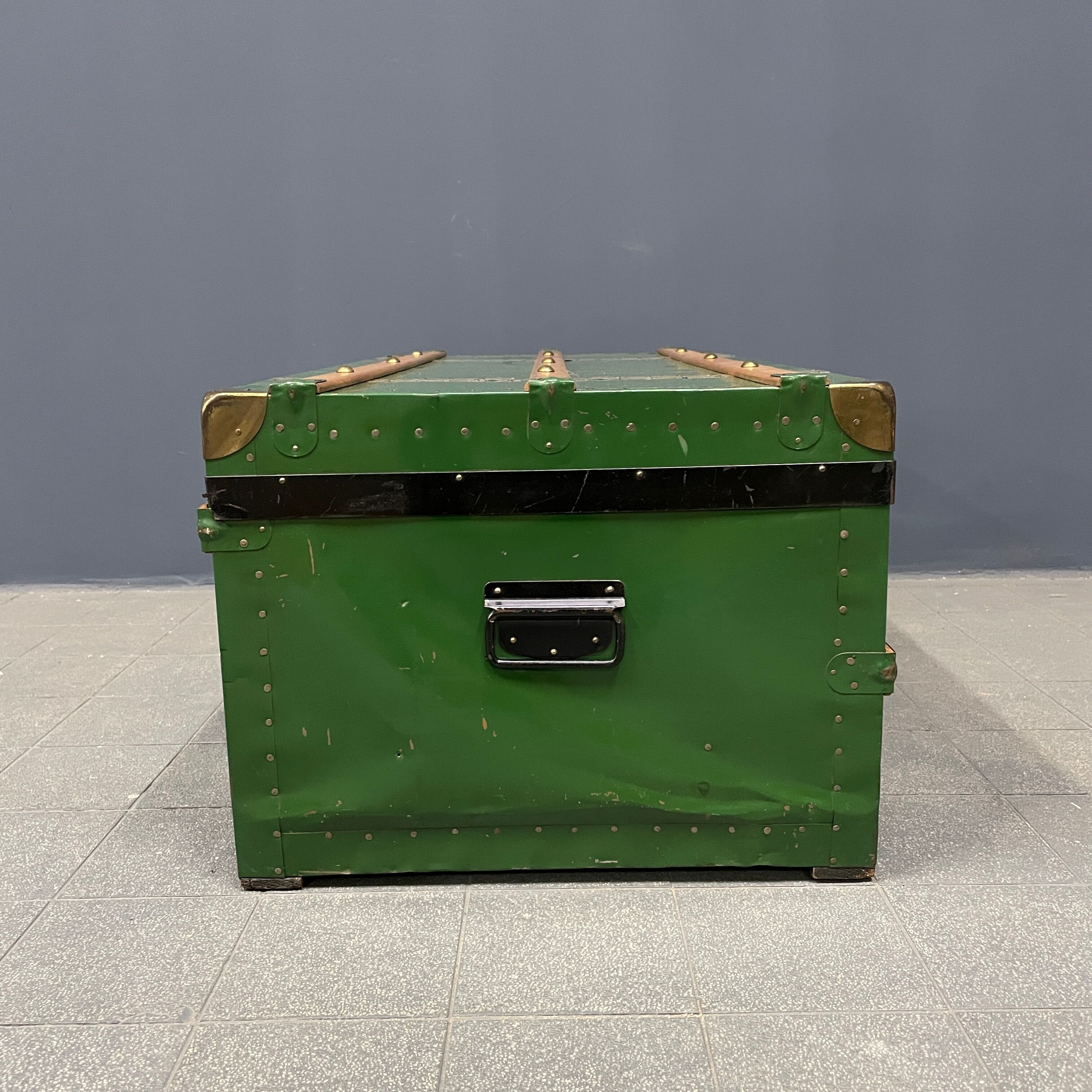 Green metal trunk with wooden sleds