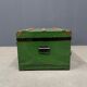 Green metal trunk with wooden sleds
