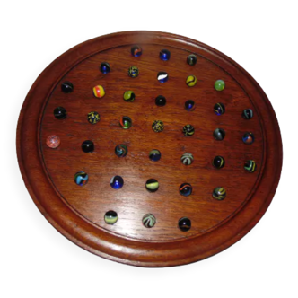 Wooden solitaire game and glass marbles