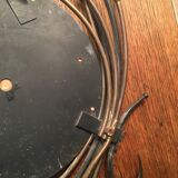 Round mirror surrounded by art deco style metal plants