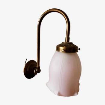 Brass wall lamp with pale pink bell