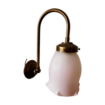 Brass wall lamp with pale pink bell
