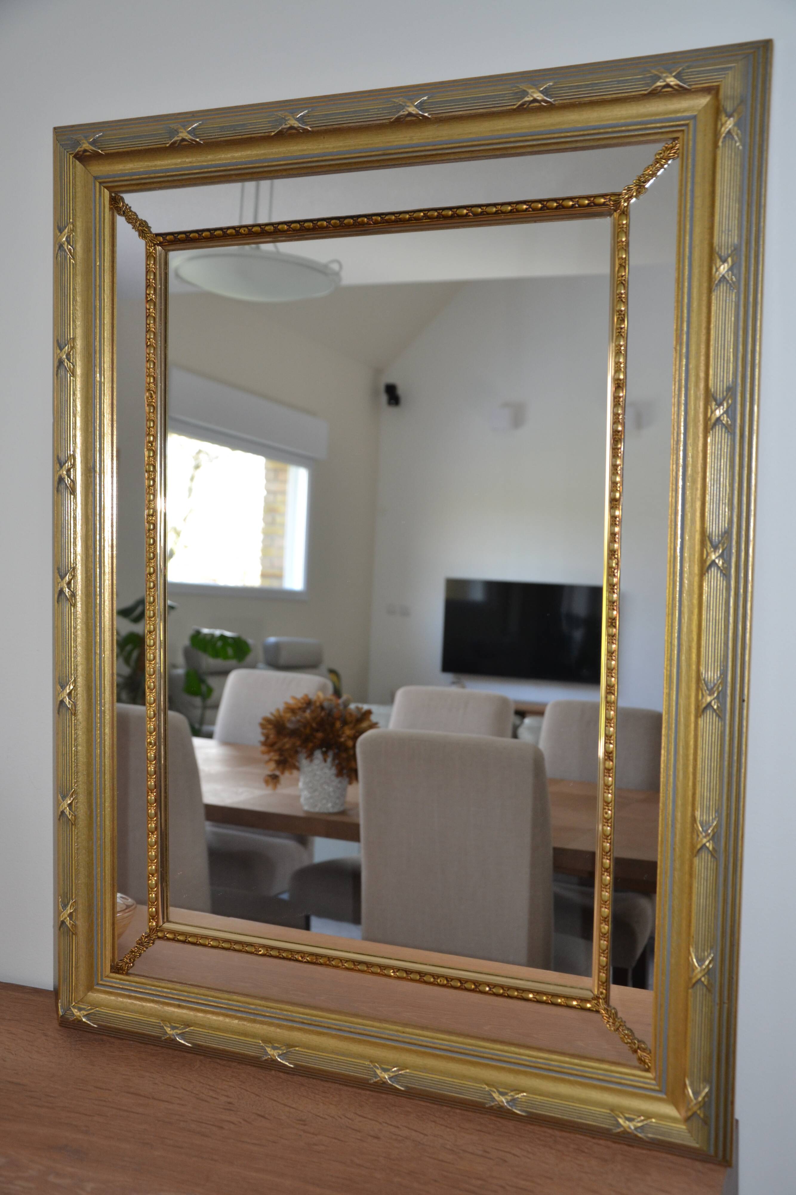 Large mirror with wooden gilded and carved frame.