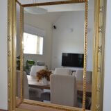 Large mirror with gilded and carved wooden glazing beads