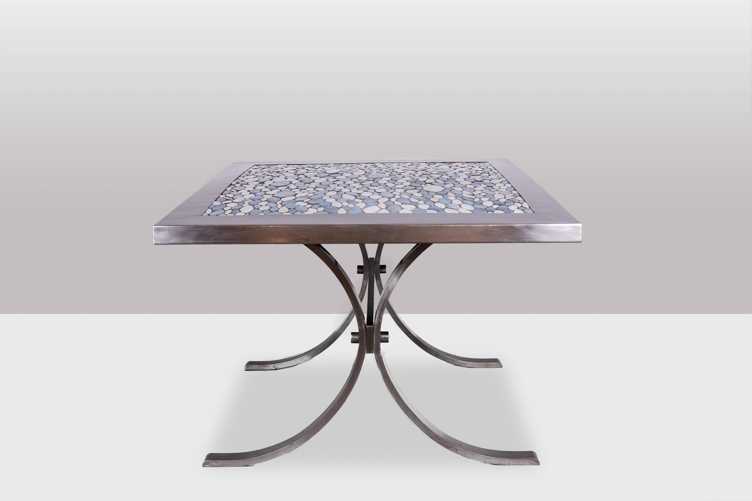 Polished metal and ceramic dining table. 1970s.