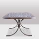 Polished metal and ceramic dining table. 1970s.