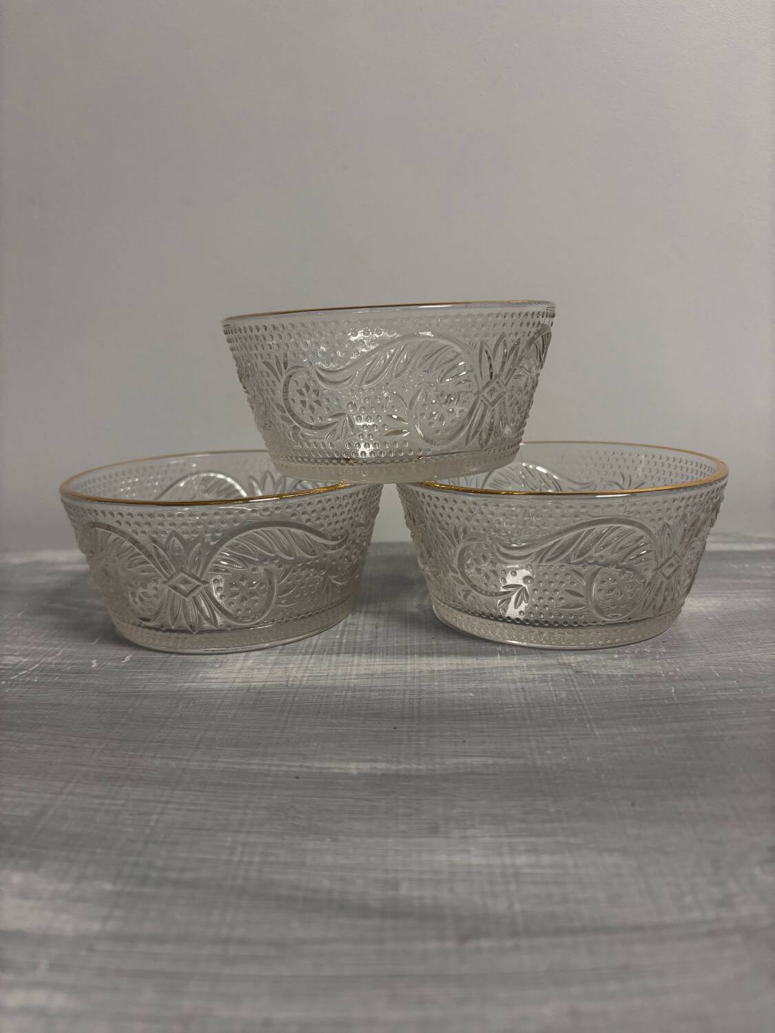 Set of 3 glass bowls with gold embellishments.