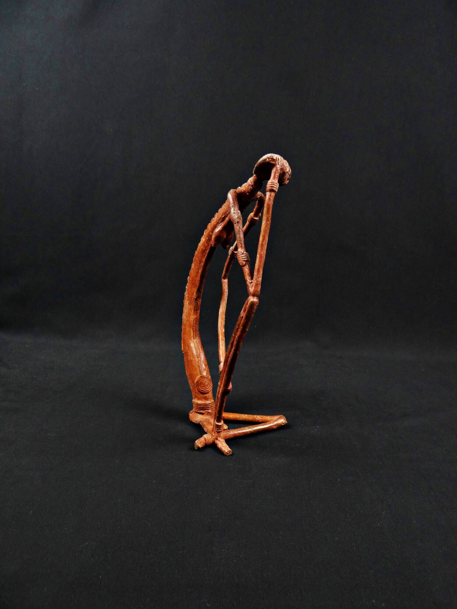 Dogon Nommo bronze statue with brown patina and red highlights, mid-20th century