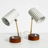 A pair of mid-century modern bedside lamps with perforated metal shades