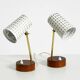 A pair of mid-century modern bedside lamps with perforated metal shades