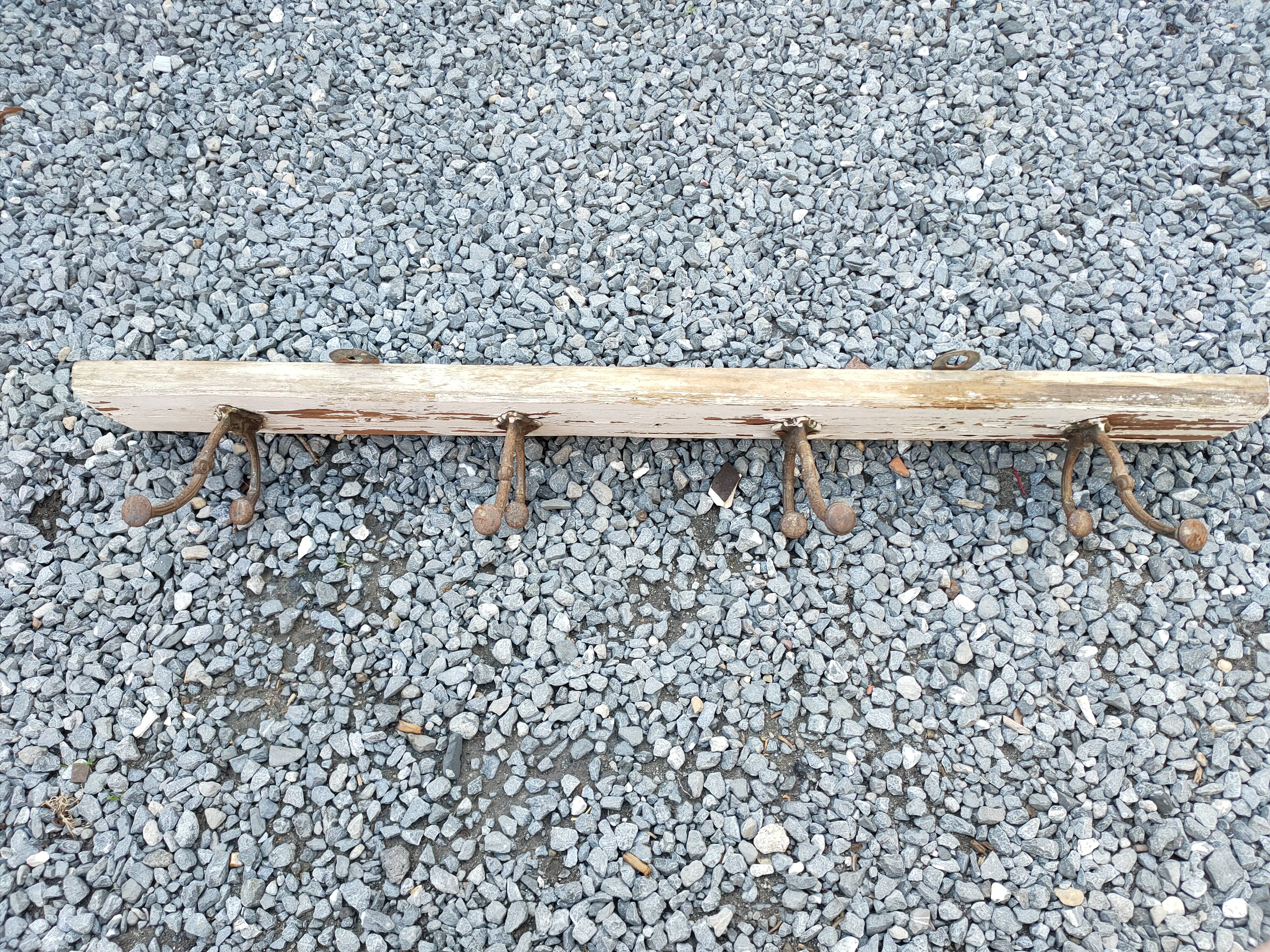 antique coat rack with 4 cast iron hooks