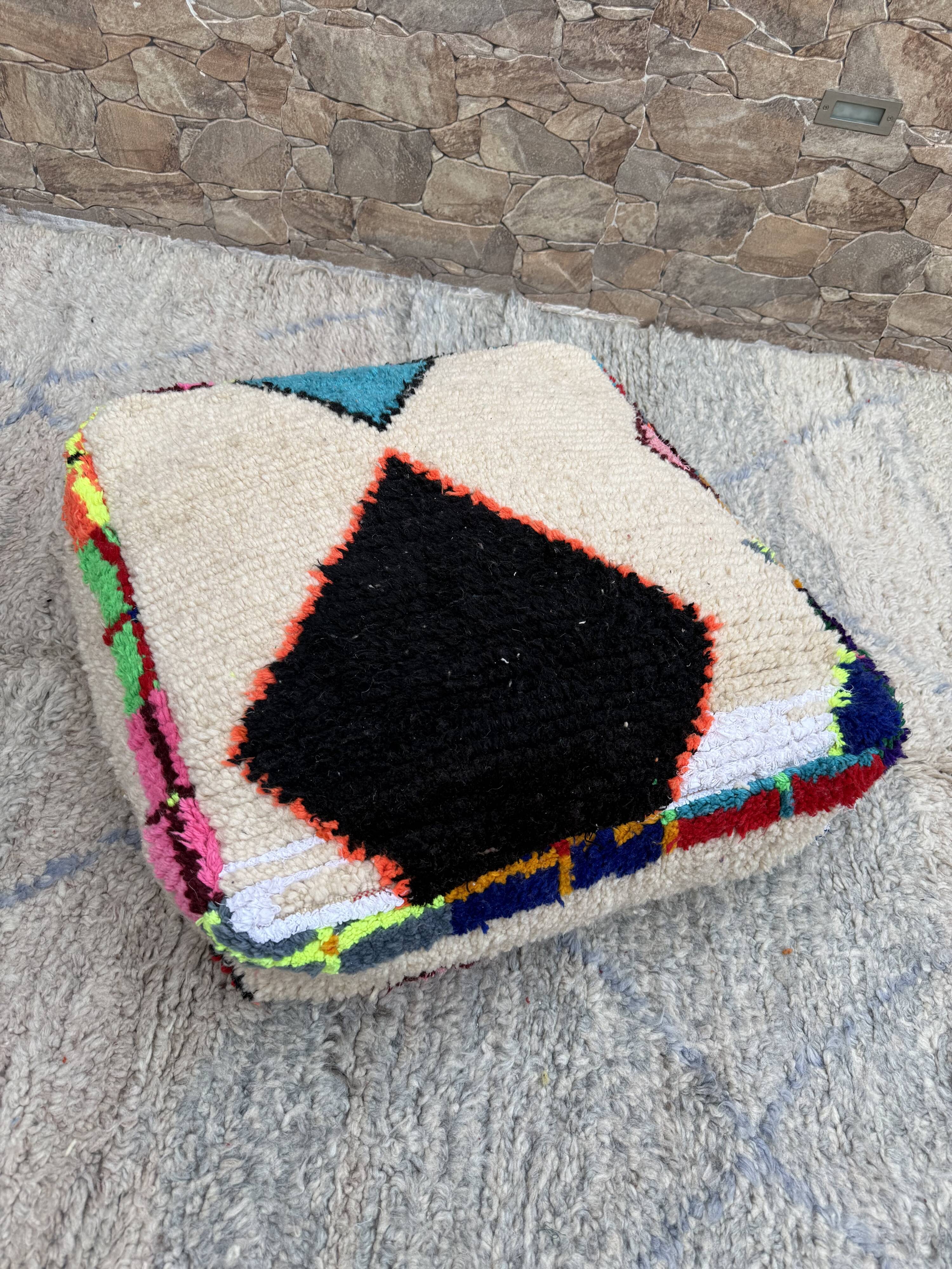 Berber floor pouf: Handwoven Moroccan wool cushion.
