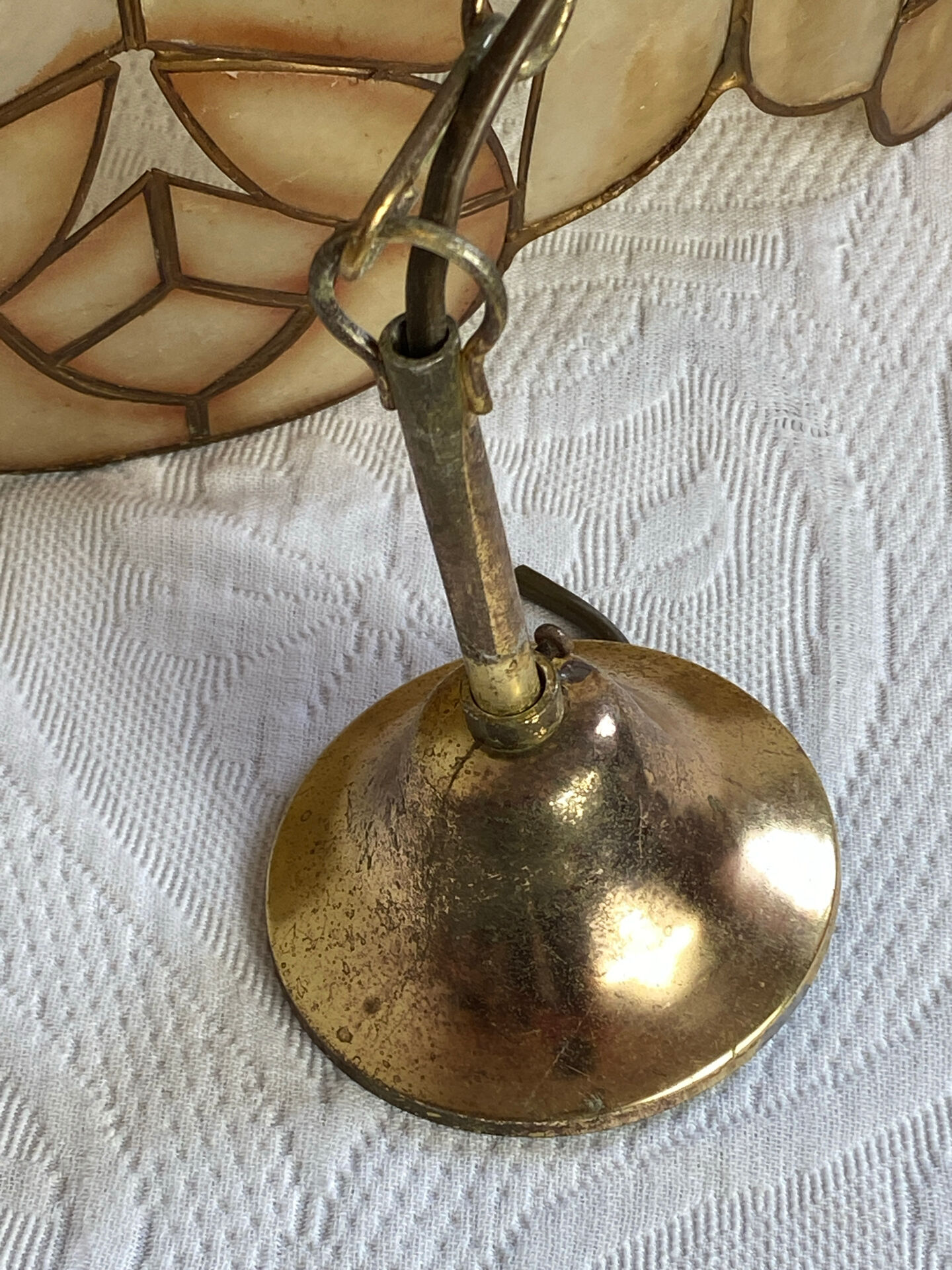 Large mother-of-pearl and brass chandelier with floral decoration.