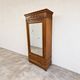 Armoire ancienne à miroir et décors sculptés