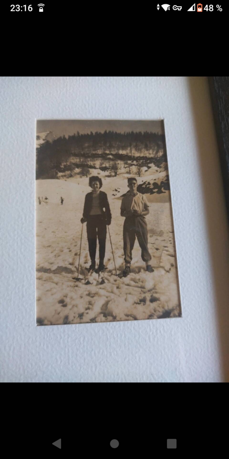 Framed vintage photograph of skiers.