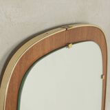 Wonderful 1950s mirror on a teak wood panel with brass frame. Made in Germany