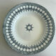A deep plate in blue and green ironstone, antique French earthenware.