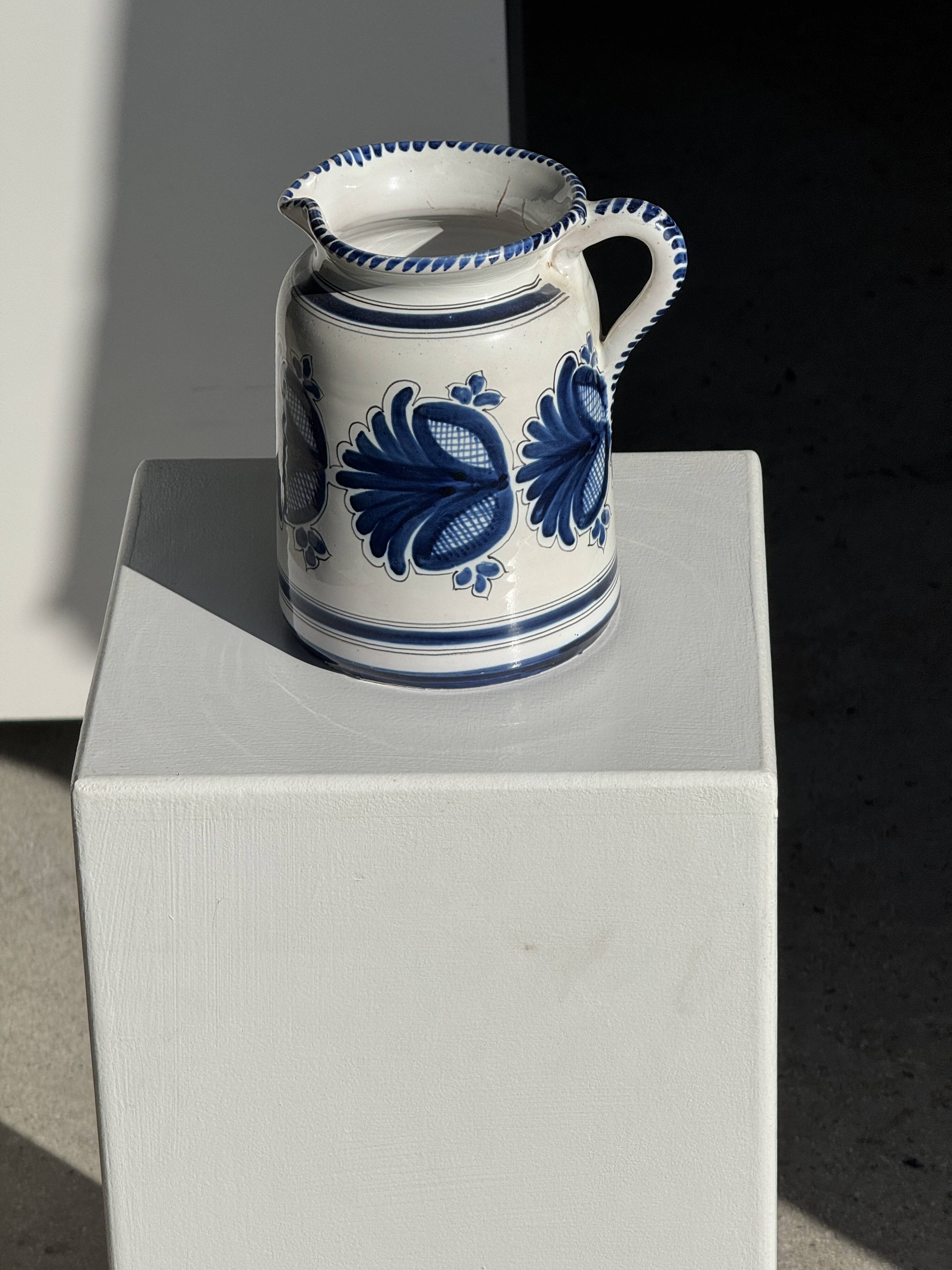 Artisan blue floral decorative carafe, height 17 cm, diameter 24.5 cm.