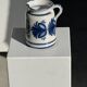 Artisan blue floral decorative carafe, height 17 cm, diameter 24.5 cm.