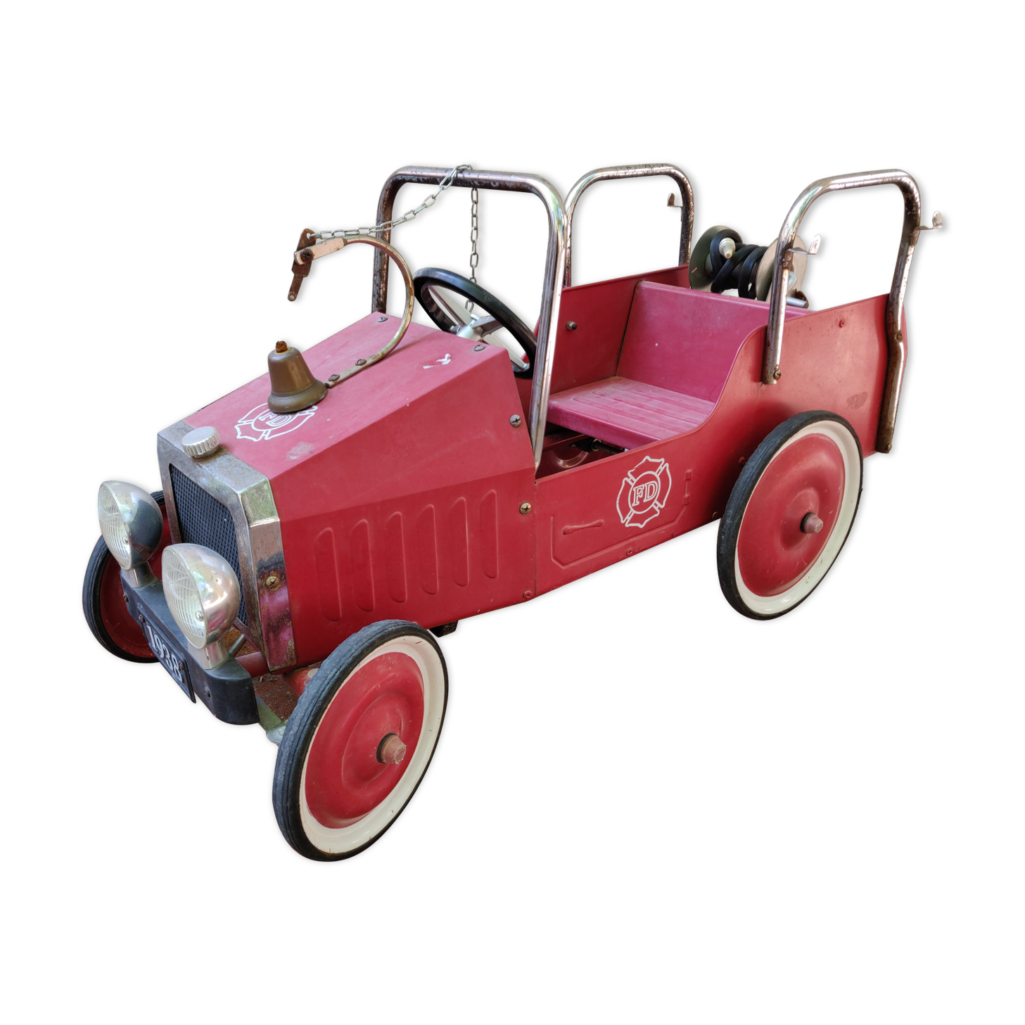 Old pedal car in tole fire truck