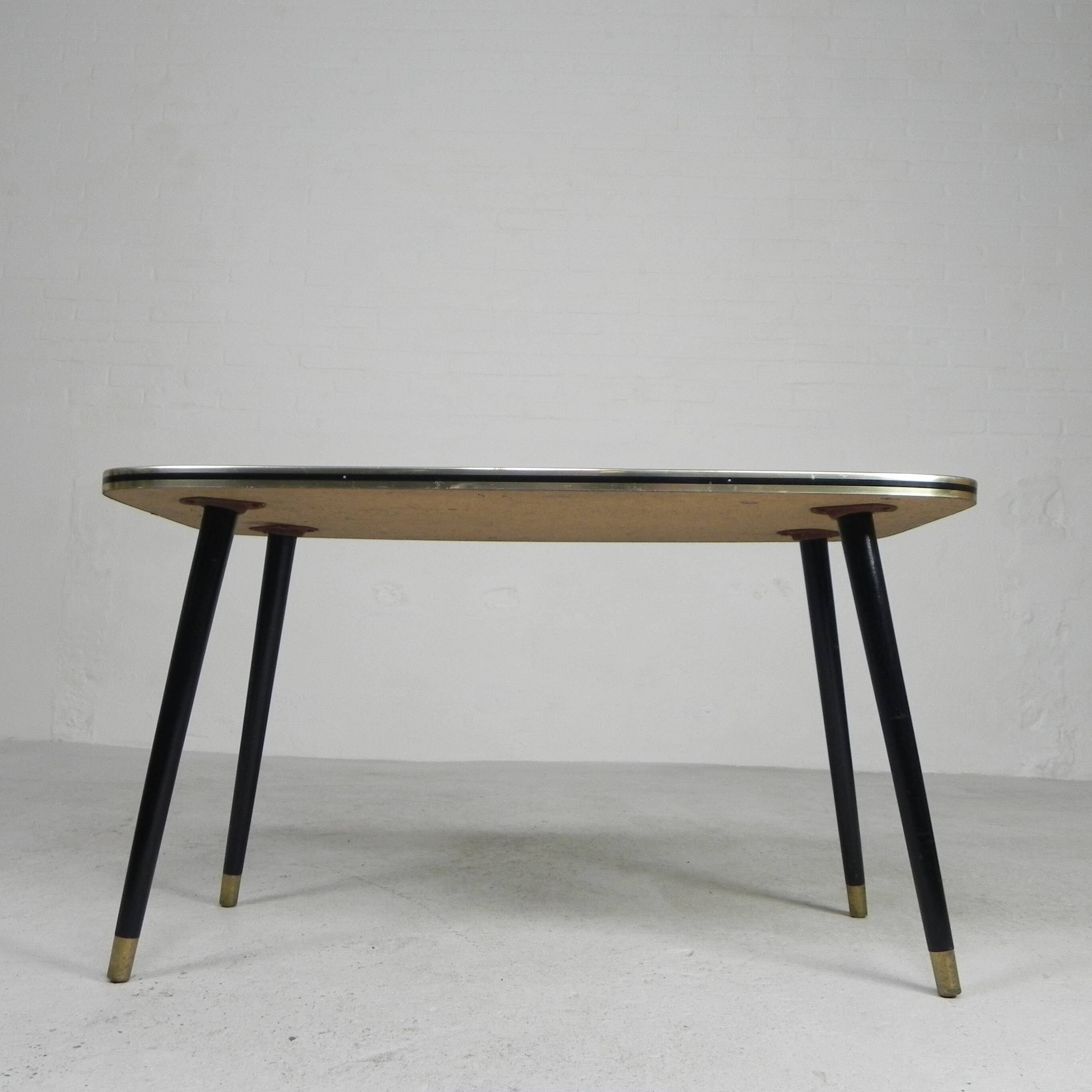Vintage coffee table with glass top and angled legs