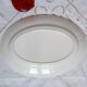 Old mismatched earthenware dinner plates with gold accompanied by a dish