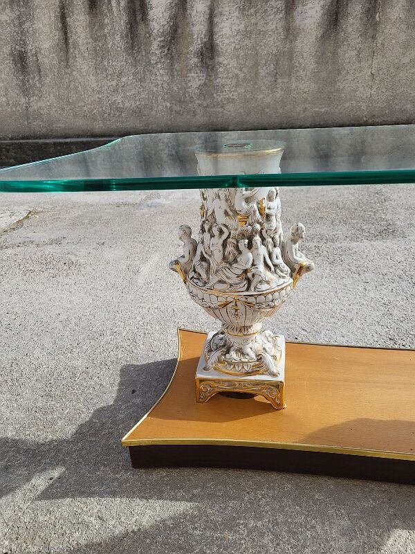 Italian coffee table with glass top, wooden base, and porcelain legs