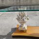 Italian coffee table with glass top, wooden base, and porcelain legs