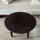 Antique round coffee table in Indonesian teak with turned legs.