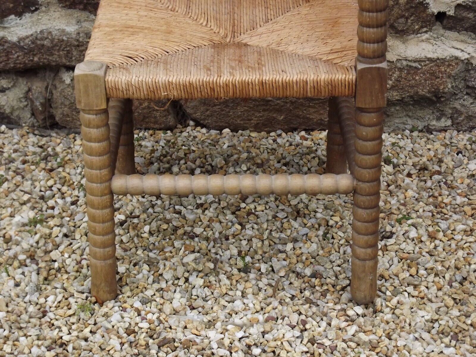 French antique turned wooden bobbin chair with rush seat
