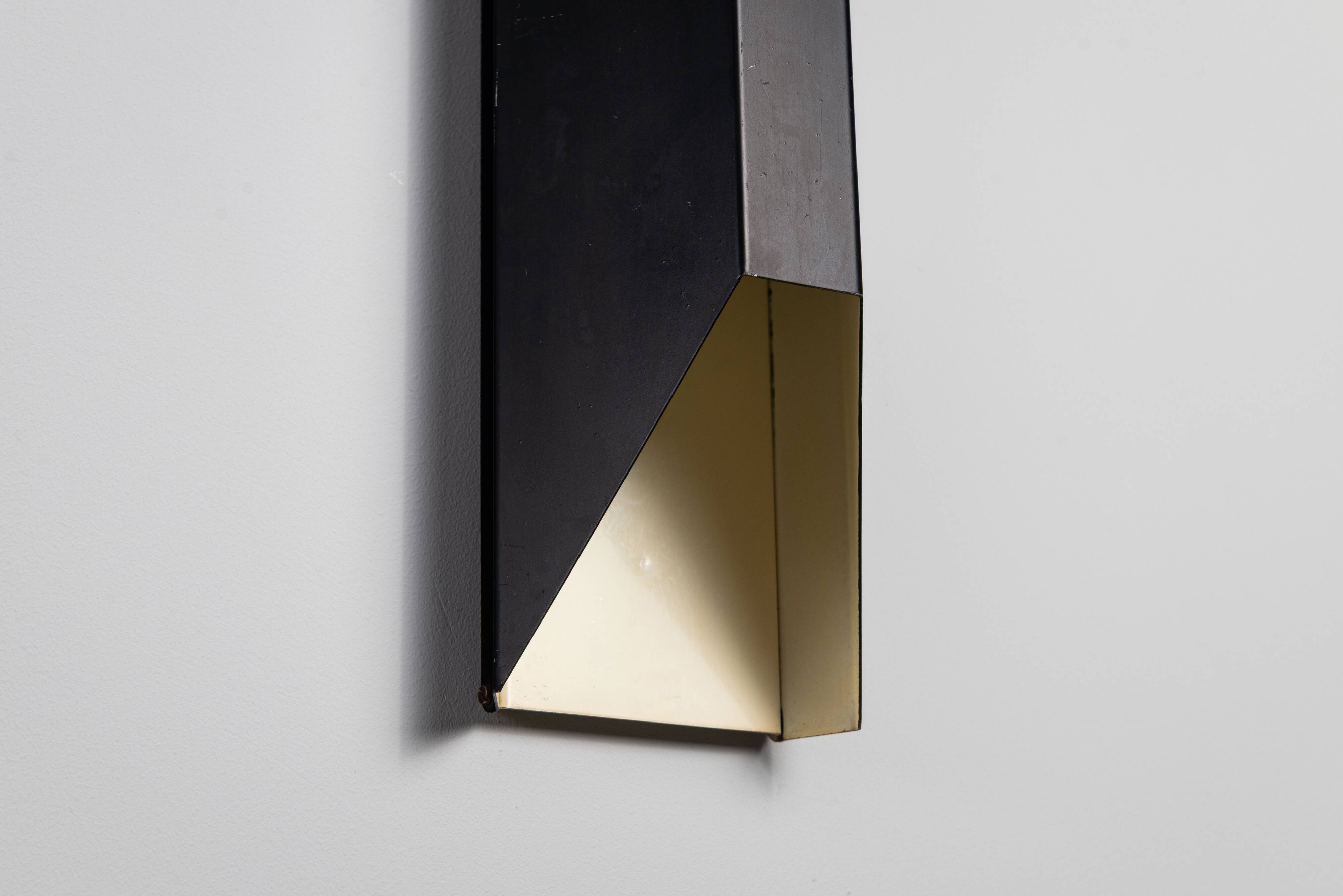 Architectural pair of vintage black metal wall lamps with angular geometric